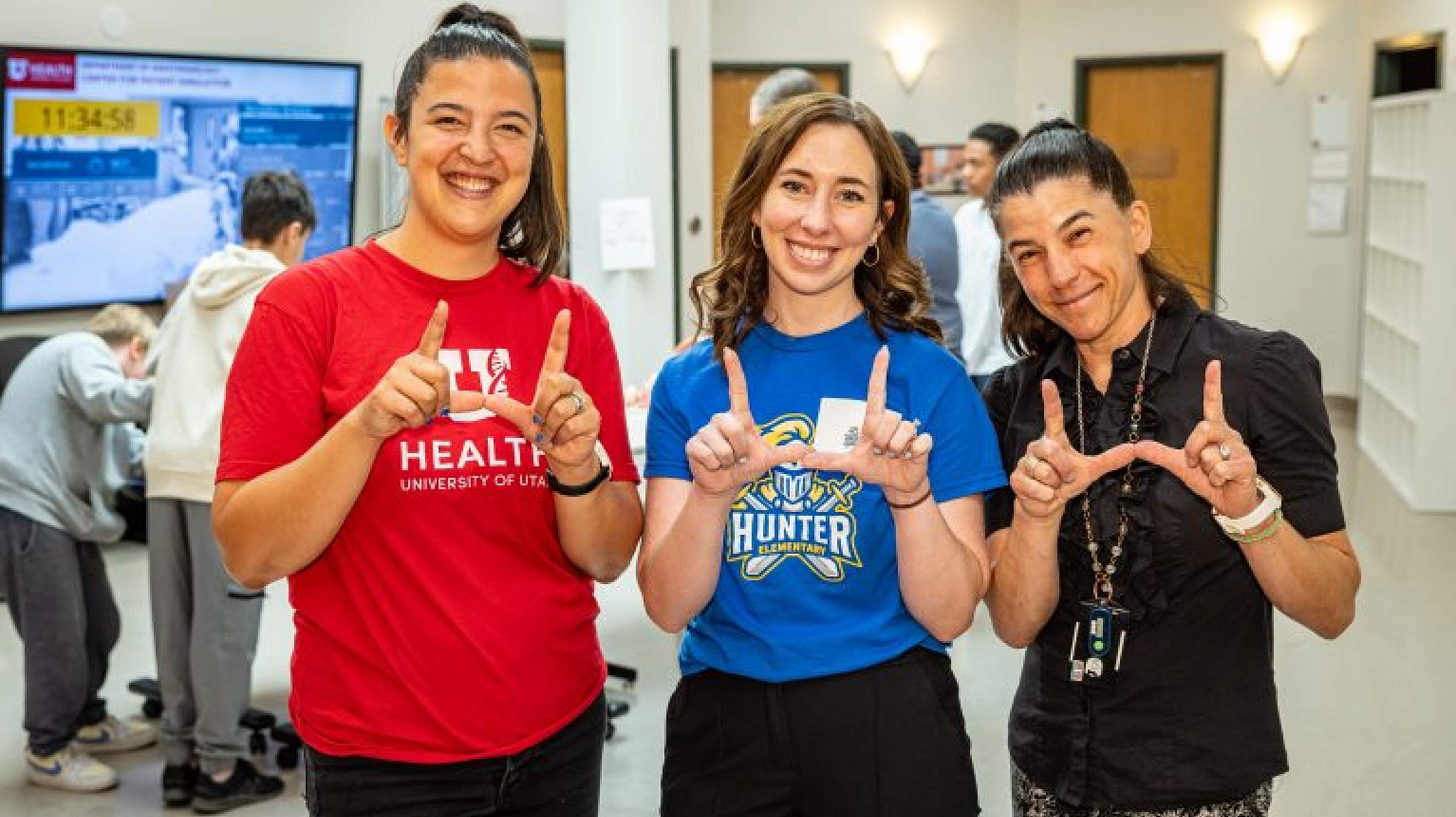 RyLee Curtis, director of community engagement, Kathlyn Anderson, principal of Hunter Elementary, and Emily Hagn, M.D.